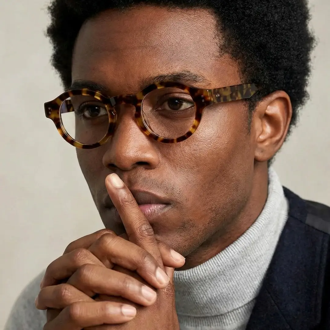 Front view of male wearing vintage tortoise round eyeglasses, thoughtful expression, RA0302504