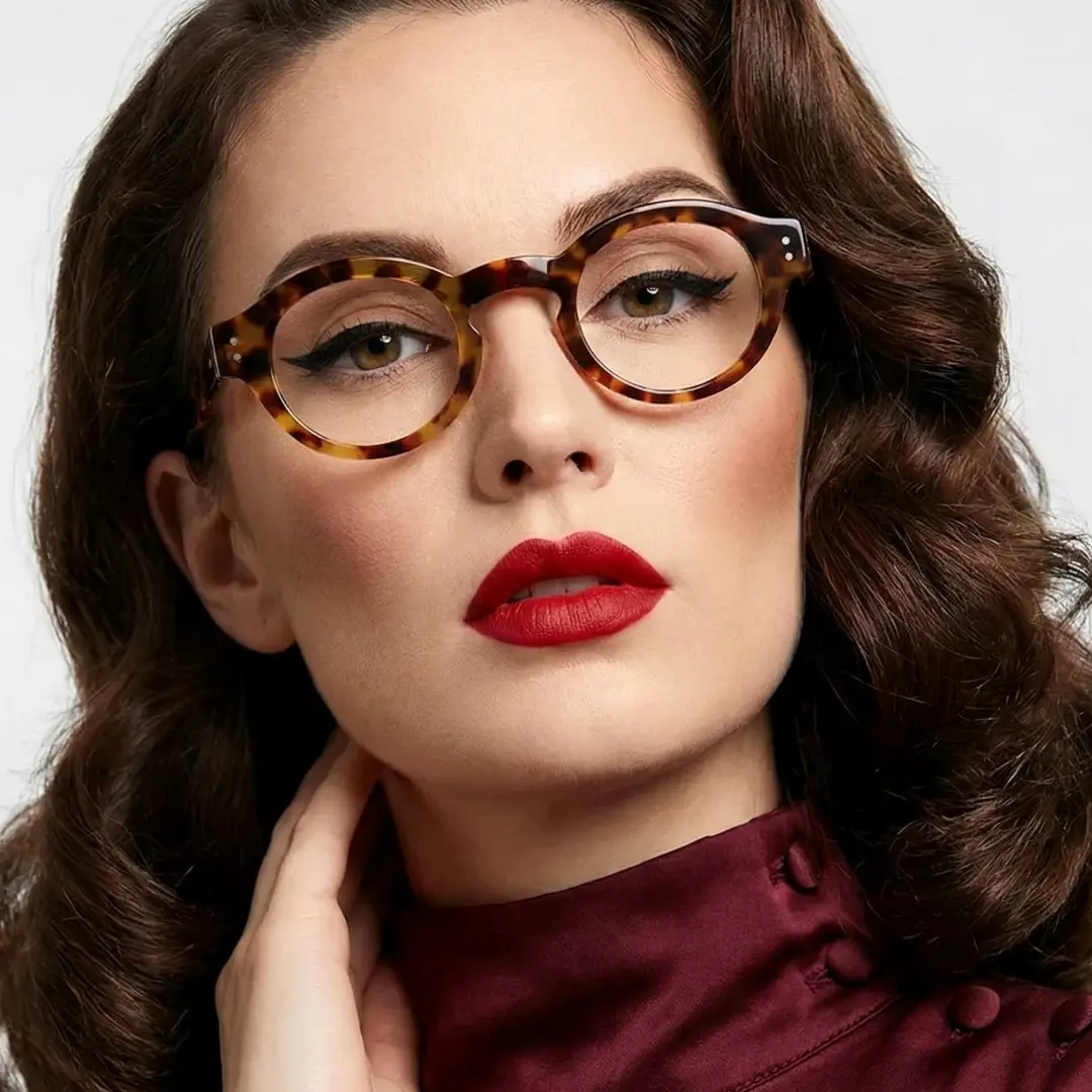 Slightly angled view of female wearing vintage tortoise round eyeglasses, hand touching shoulder, confident expression, RA0302504