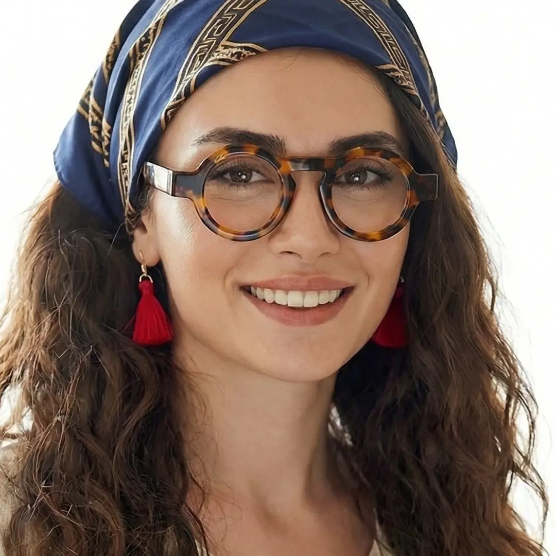 Profile view of female wearing tortoise round eyeglasses, natural smile, RA0312411