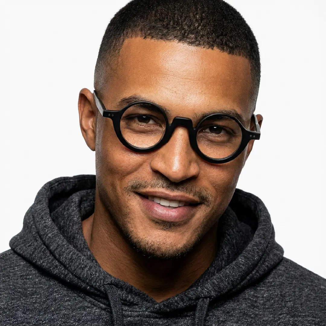 Front view of male wearing vintage black round eyeglasses, natural smile, RA0322504