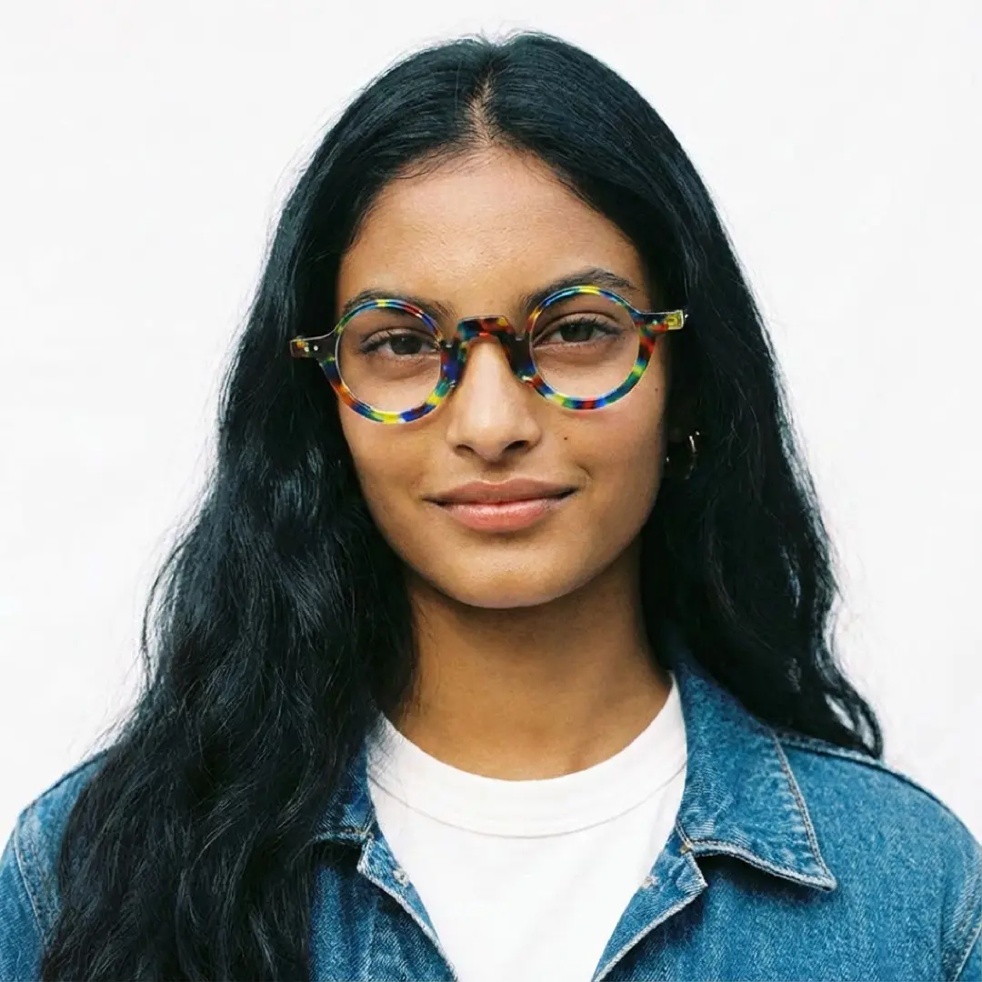 Front view of female wearing multicolor round eyeglasses, smiling, RA0322504