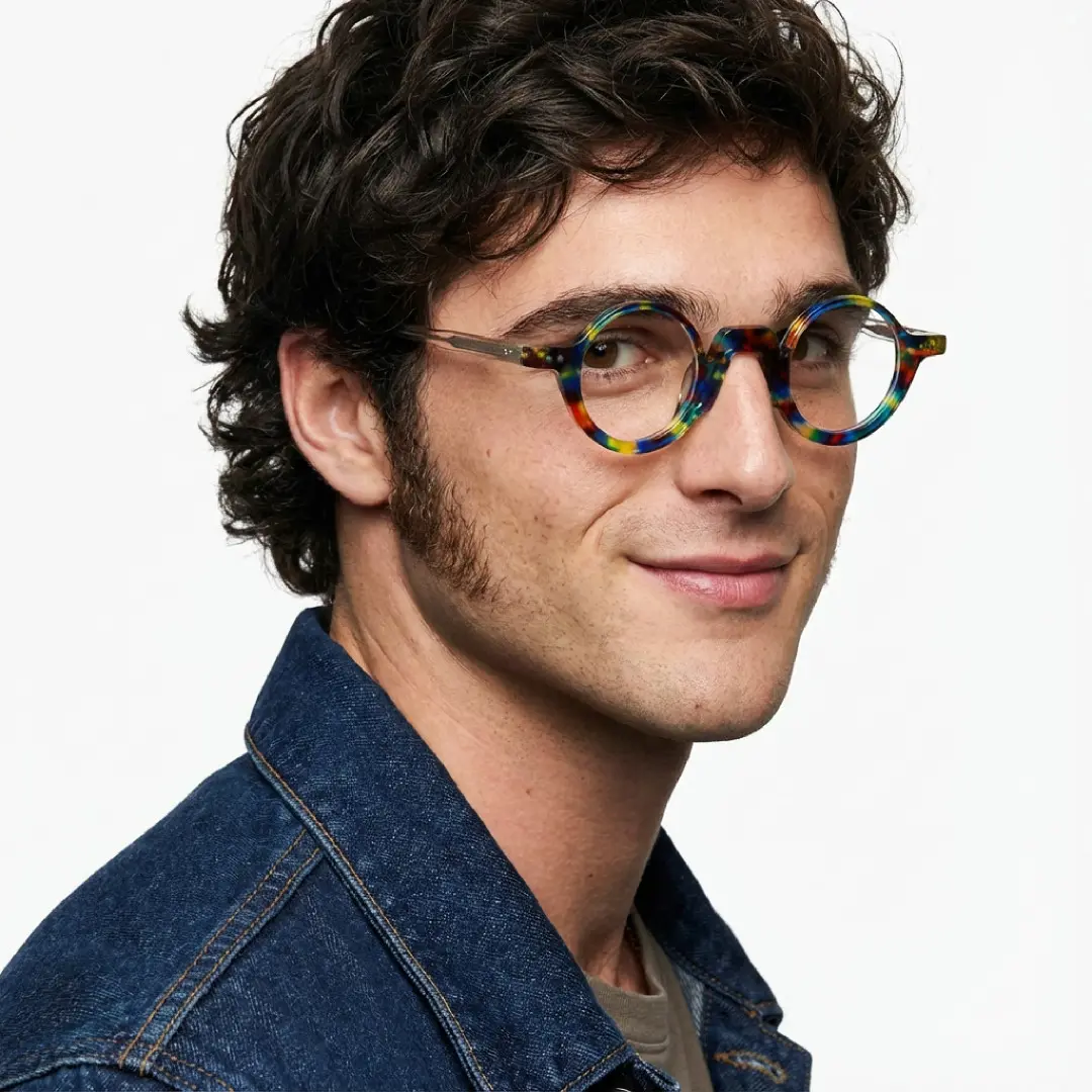 Over-the-shoulder view of male wearing vintage multicolor round eyeglasses, smiling, RA0322504