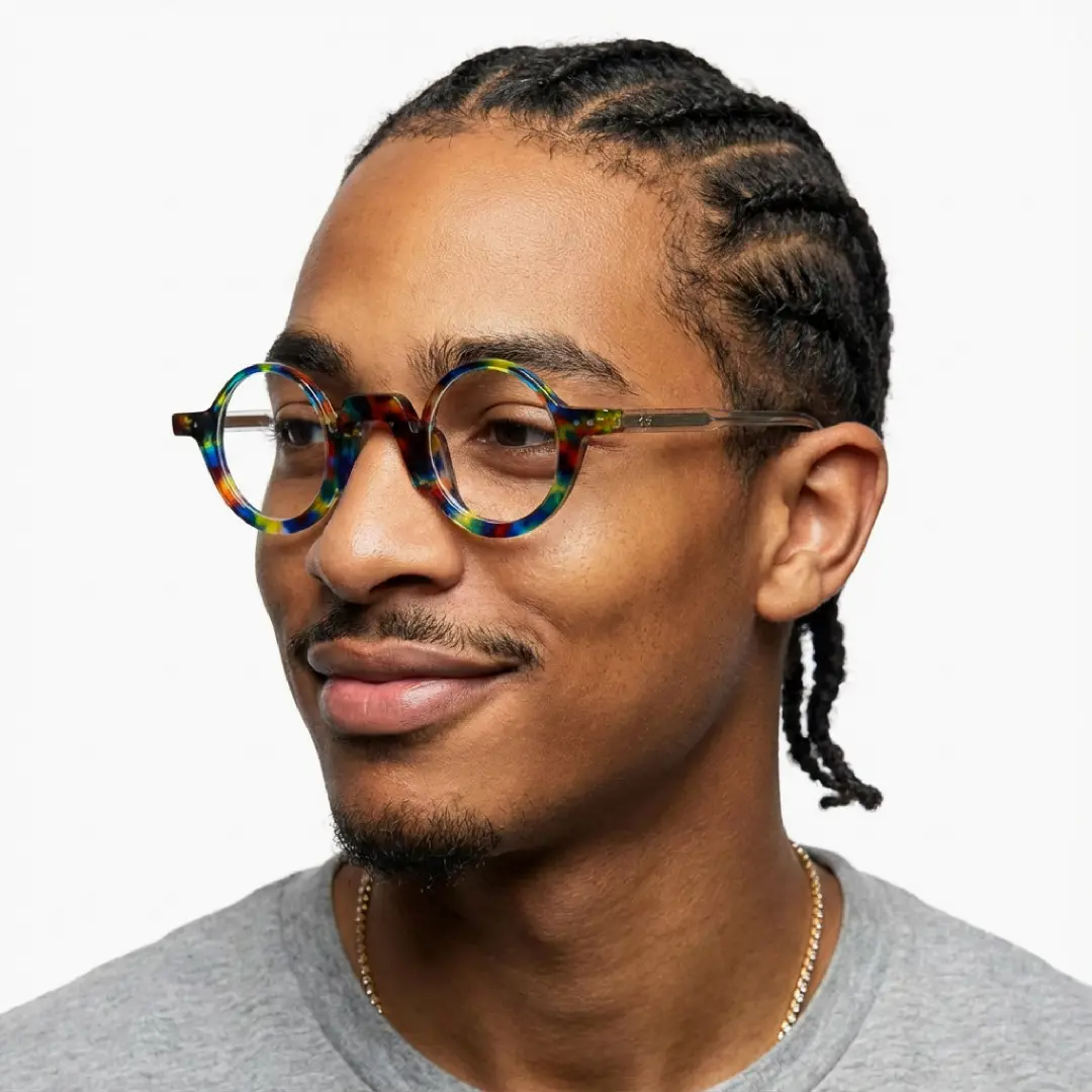 Three-quarter view of male wearing vintage multicolor round eyeglasses, natural smile, RA0322504