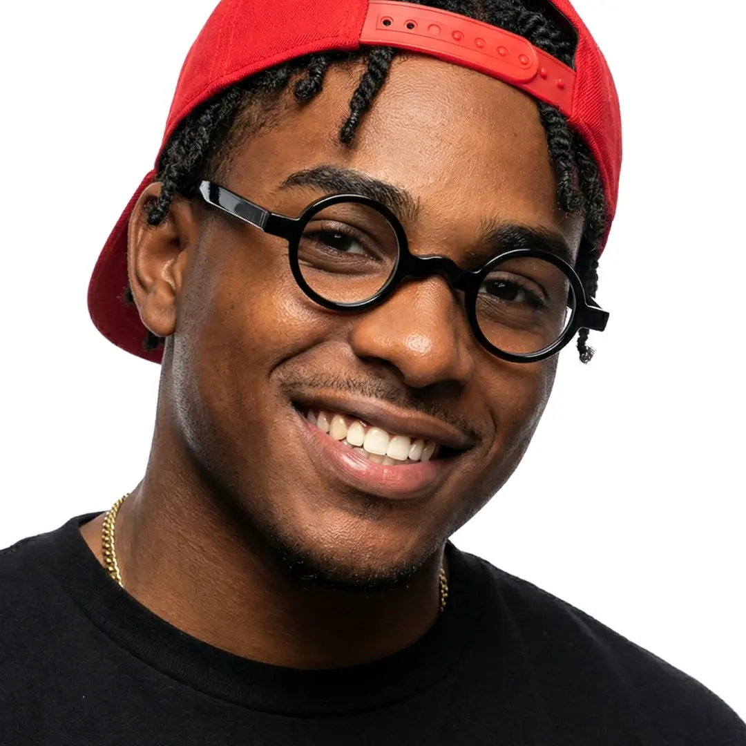Front view of male wearing vintage black round eyeglasses, tilting head, smiling, RA0332507