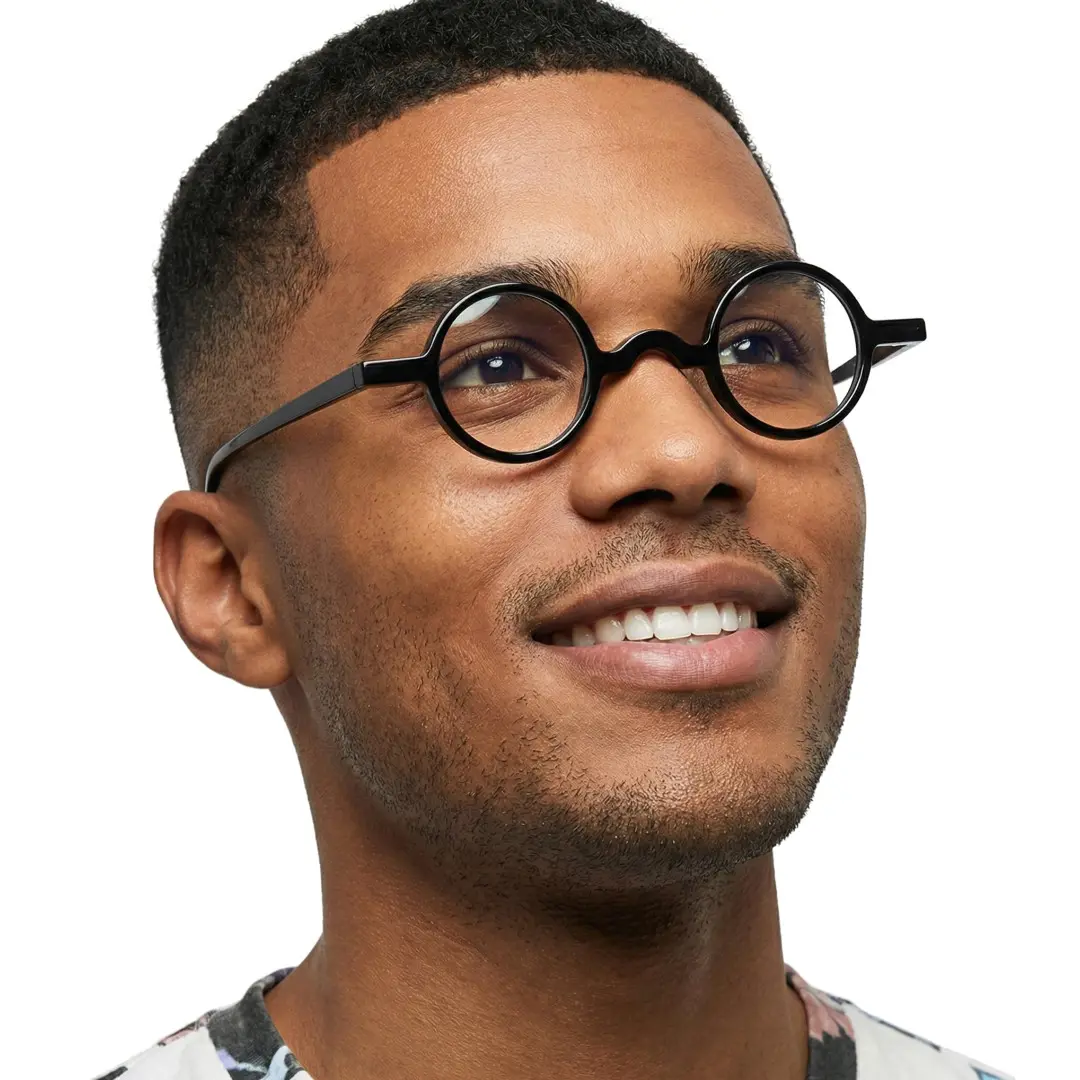 Looking away view of male wearing black round eyeglasses, smiling, RA0402411