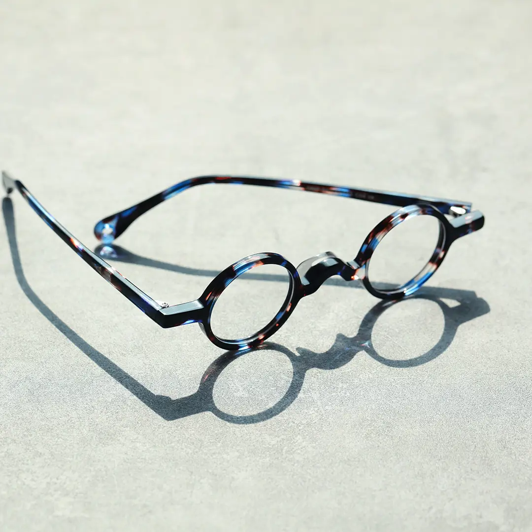 Scene close-up view of Waye vintage round acetate eyeglasses in blue tortoise. SPU: RA0402411
