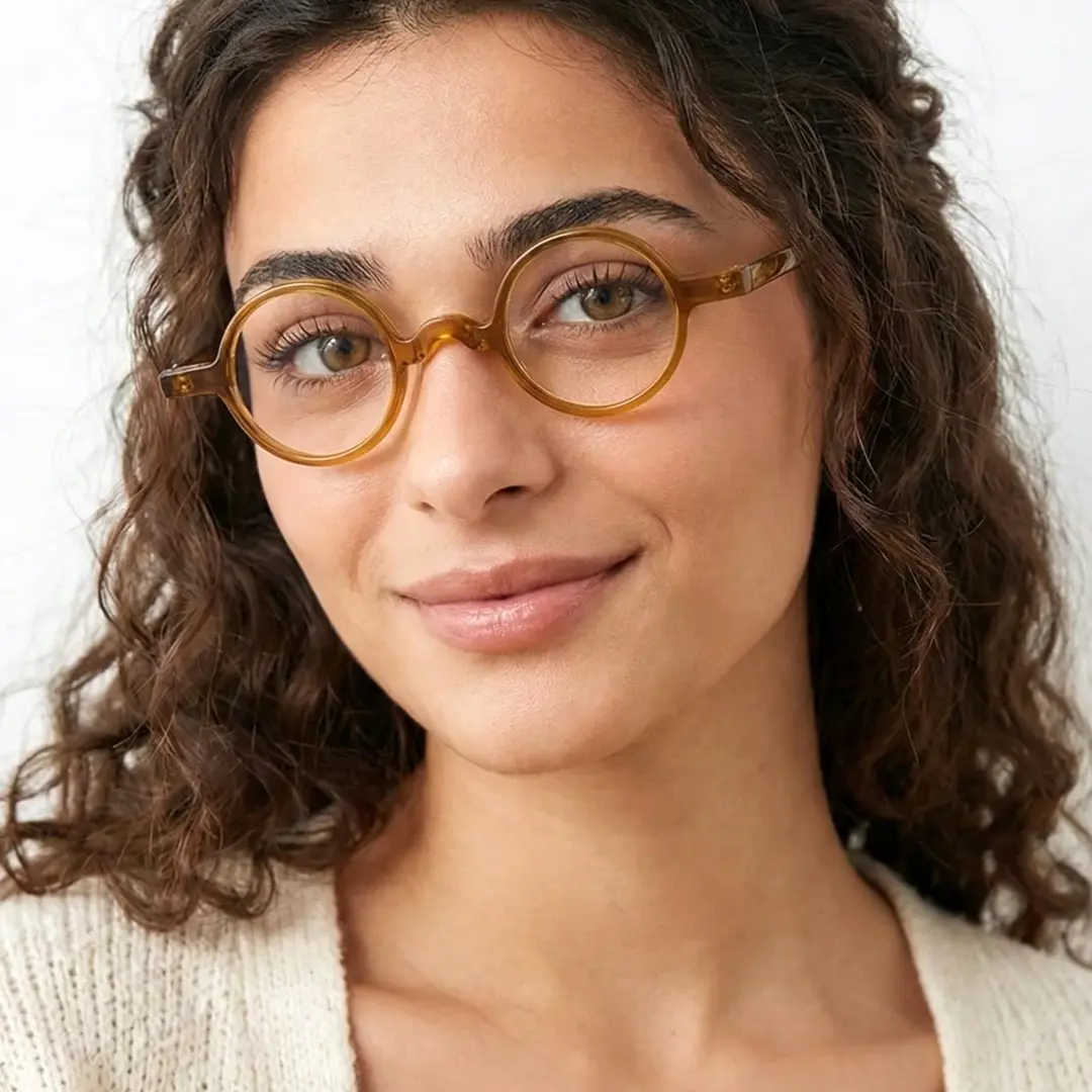Front view of female wearing vintage bronze round eyeglasses, natural smile, RA0402411