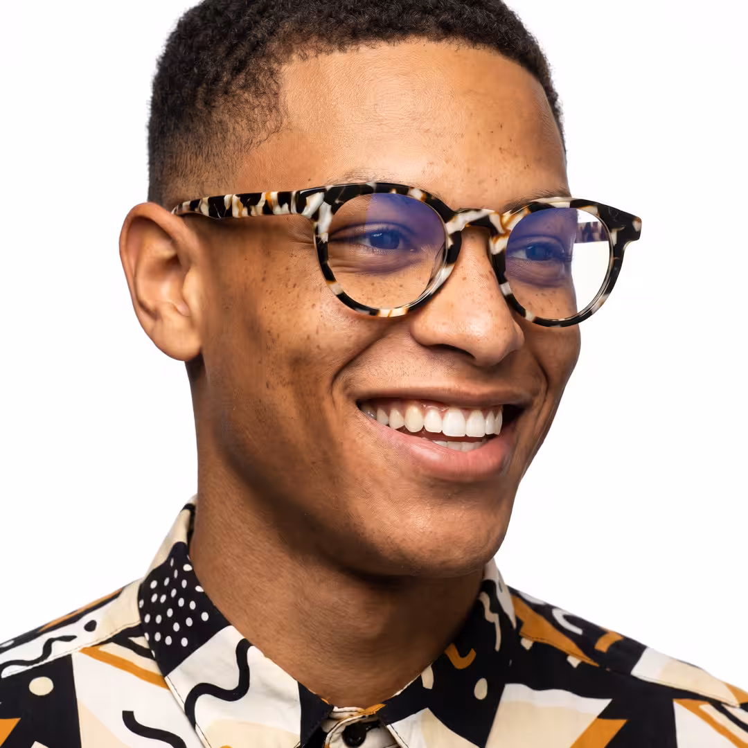 Male wearing colorful tortoise round acetate eyeglasses, smiling. SPU: RA0402605