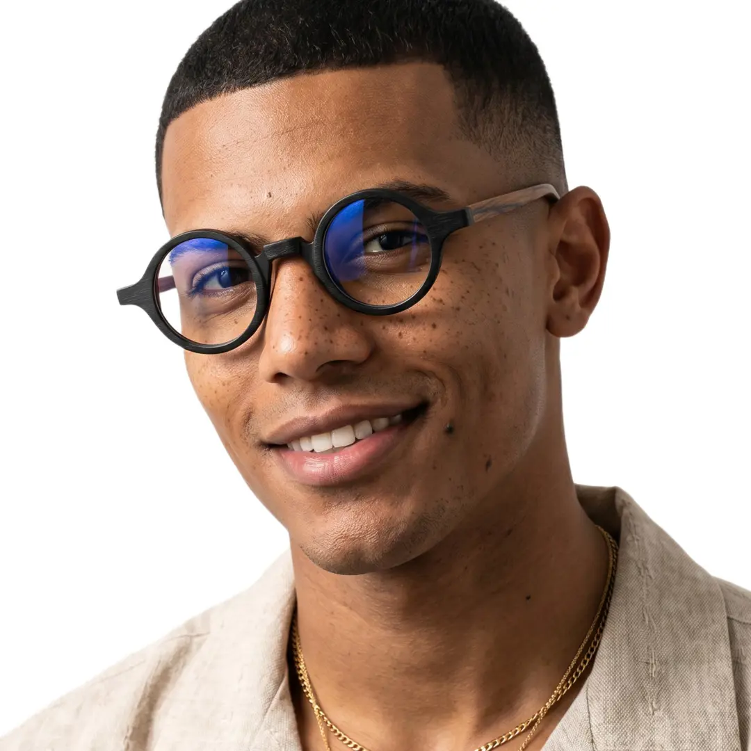 Slightly angled view of male wearing vintage black round eyeglasses, smiling, RA0572302