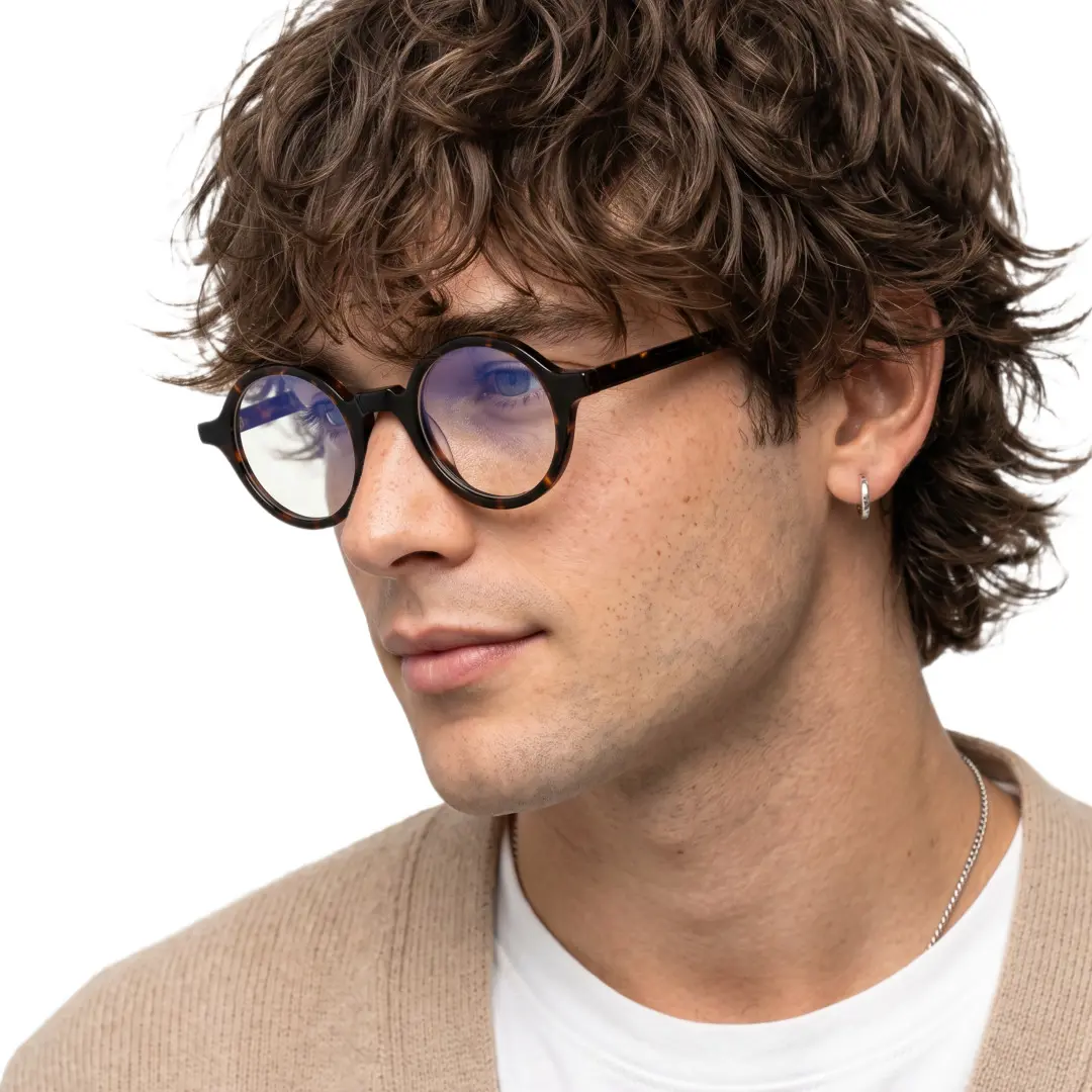 Profile view of male wearing vintage tortoise round eyeglasses, neutral expression, RA0572302
