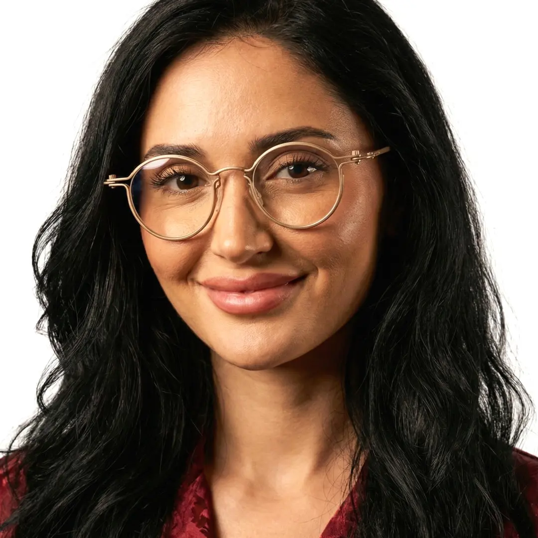 Front view of female wearing gold round eyeglasses, natural smile, RM0042208