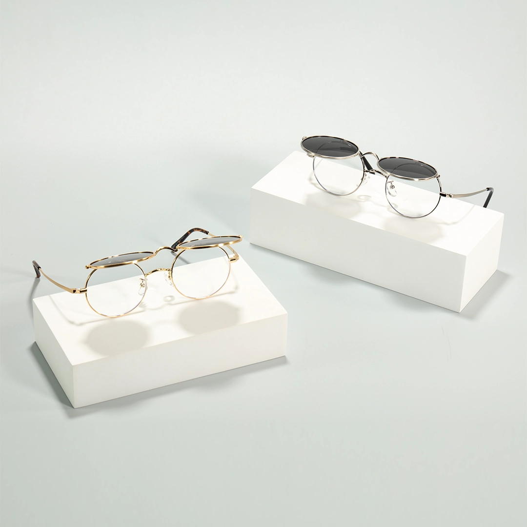 Scene close-up view of Noe round metal flip-up eyeglasses RM0042601 in gold