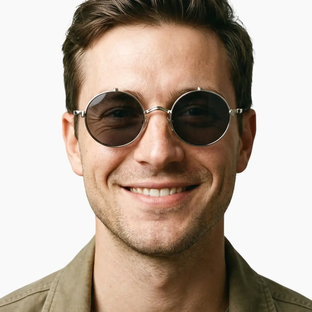 Looking straight ahead view of male wearing silver round flip-up eyeglasses, smiling, RM0042601