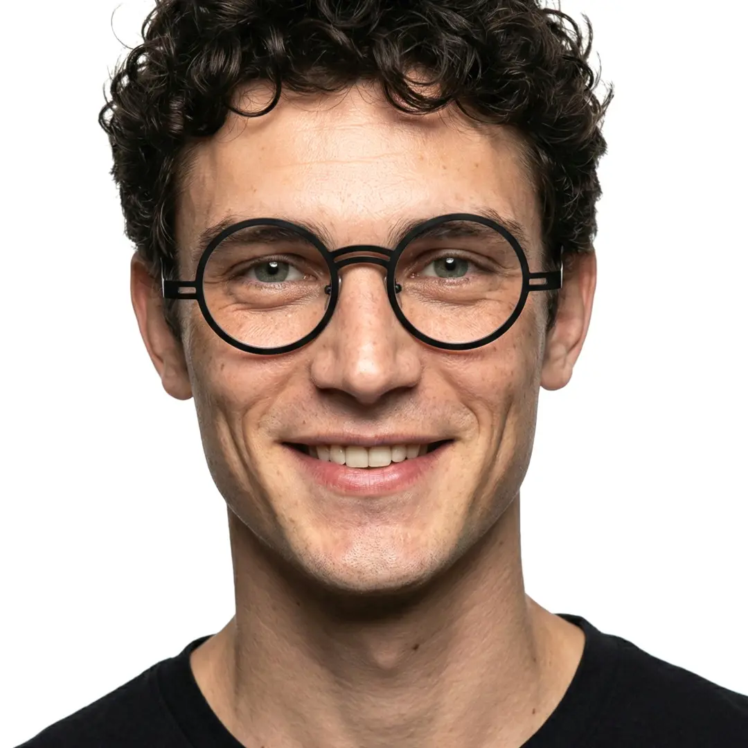 Front view of male wearing vintage black round eyeglasses, smiling, RM0052406