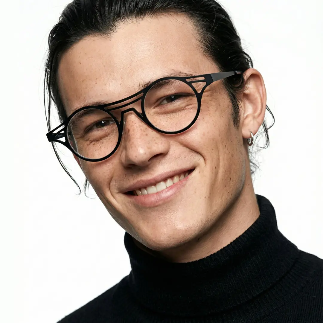 Tilted head view of male wearing black geometric eyeglasses, smiling, RM0072212