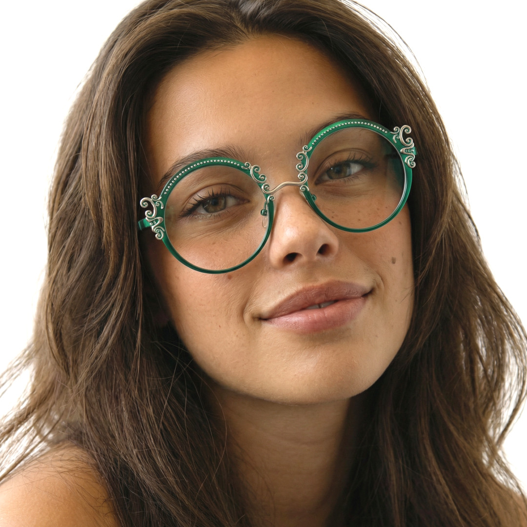 Slightly angled view of female wearing vintage green round eyeglasses, friendly smile, RM0072601