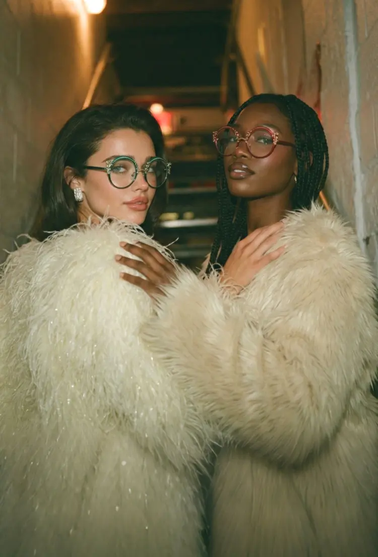 Two people model wearing vintage green and red round metal eyeglasses in a vintage stairway with white fur coats. SPU: RM0072601