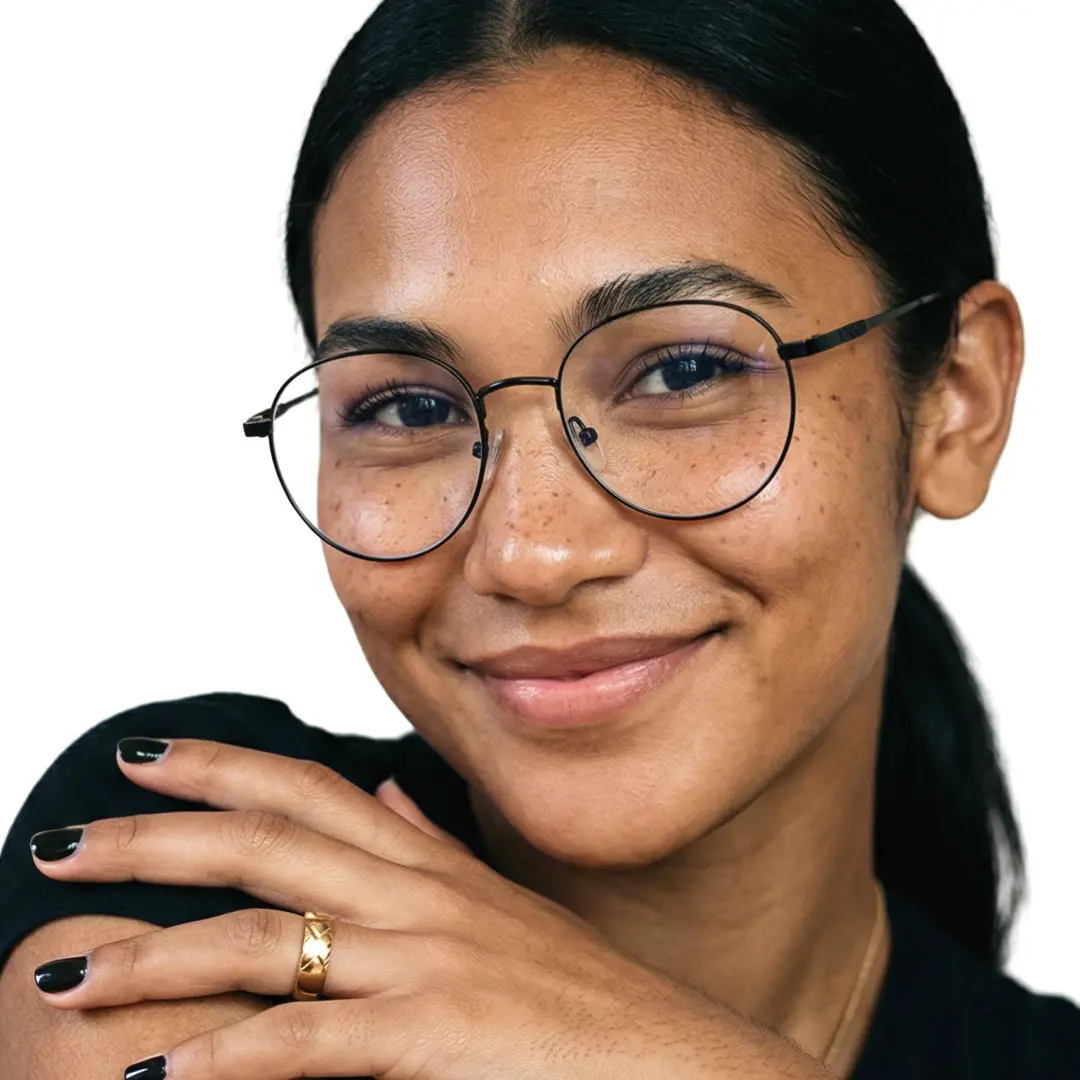 Front view of female wearing black round eyeglasses, hand touching shoulder, natural smile, RM0082209