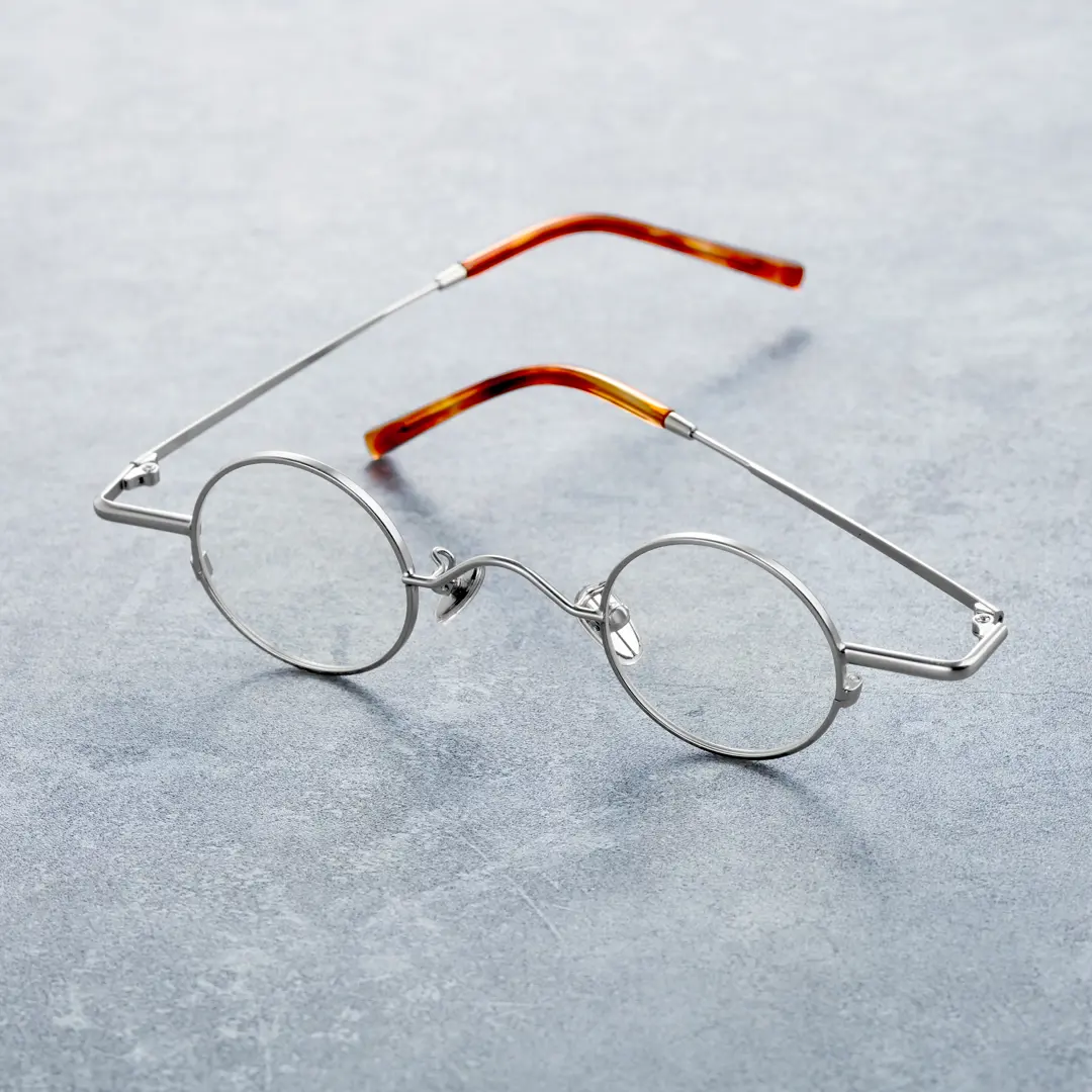Scene close-up view of Yezy round metal eyeglasses RM0082308 in silver