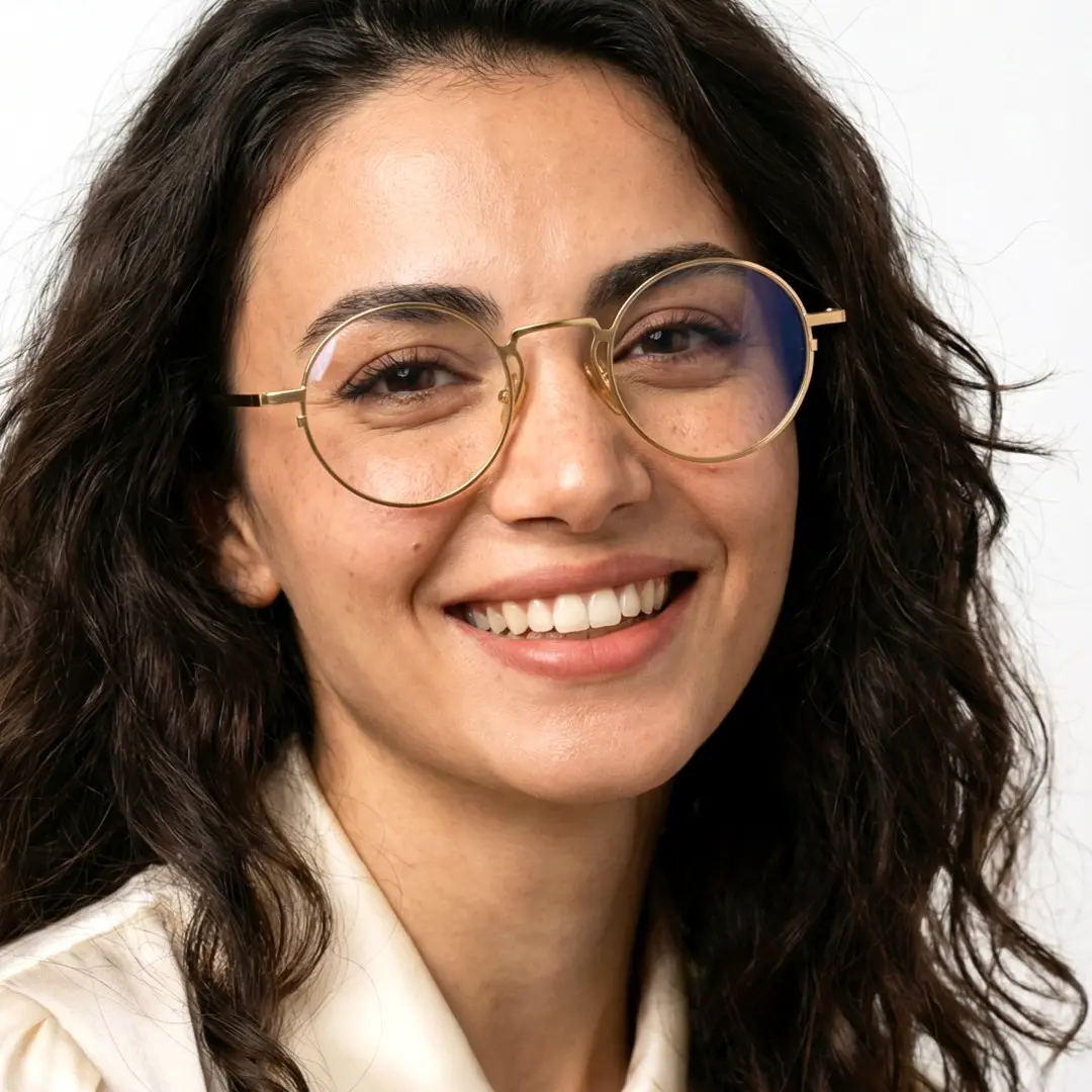 Face close-up view of female wearing john lennon gold round eyeglasses, soft smile, RM0102407