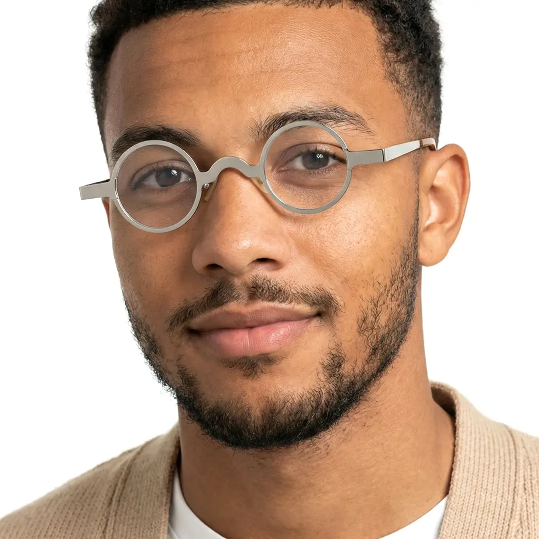Looking straight ahead view of male wearing vintage silver round eyeglasses, natural smile, RM0122404