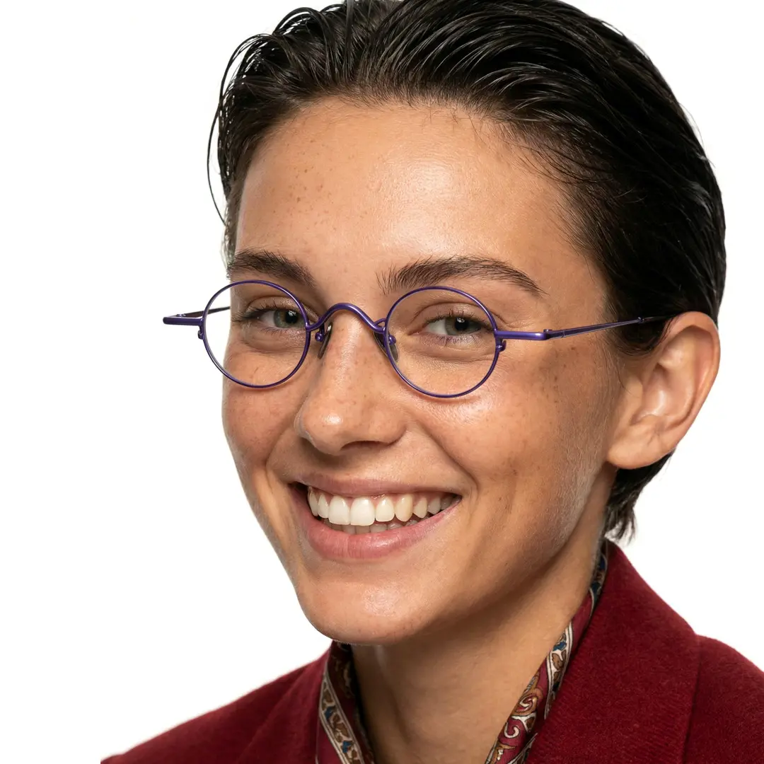 Front view of female wearing purple round eyeglasses, friendly smile, RM0202601