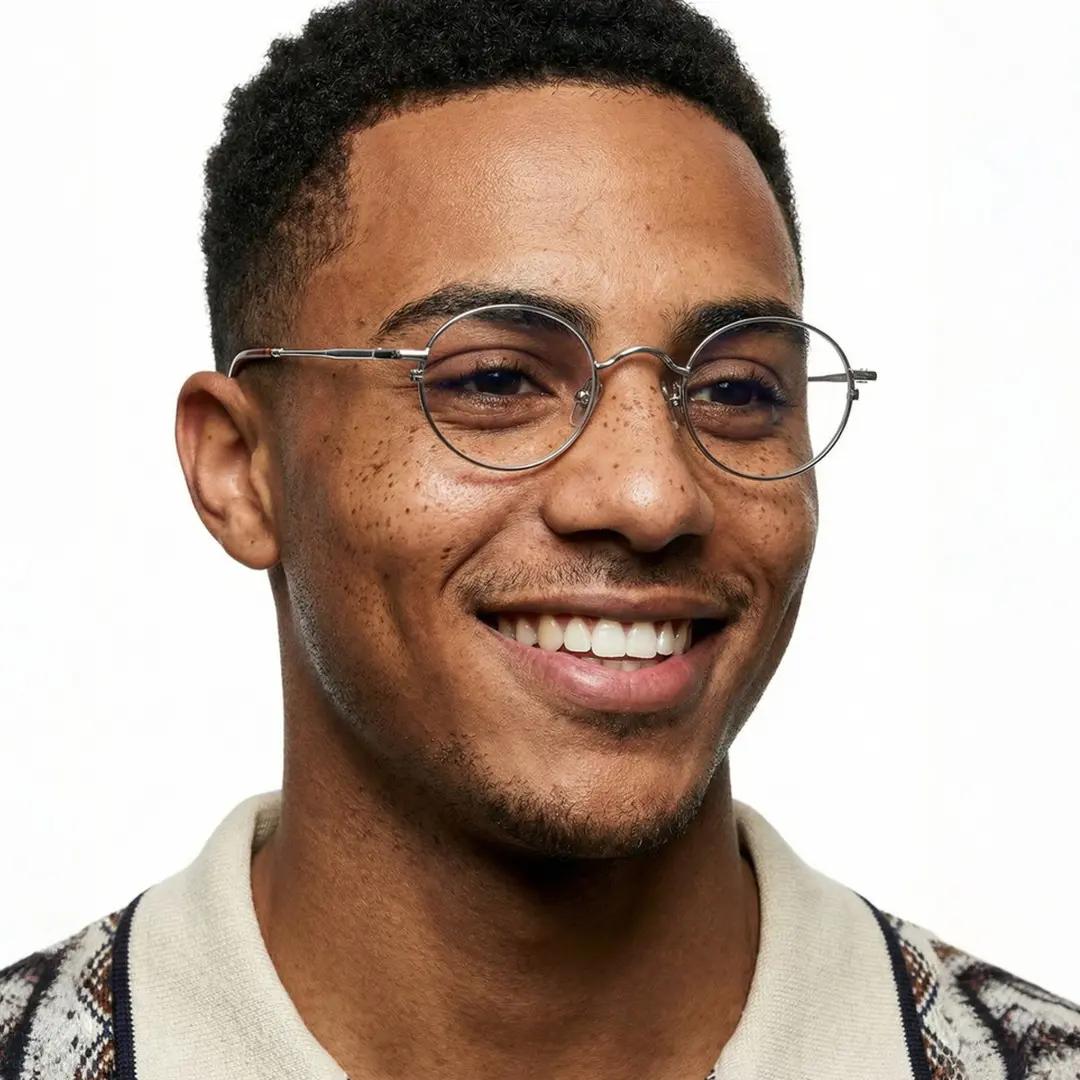 Looking away view of male wearing silver round eyeglasses, smiling, RM0202601