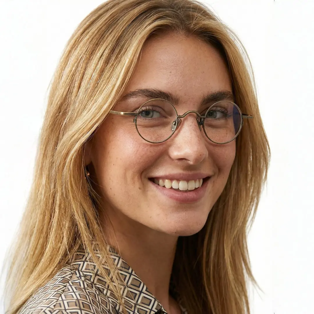 Over-the-shoulder view of female wearing vintage bronze round eyeglasses, smiling, RM0242601