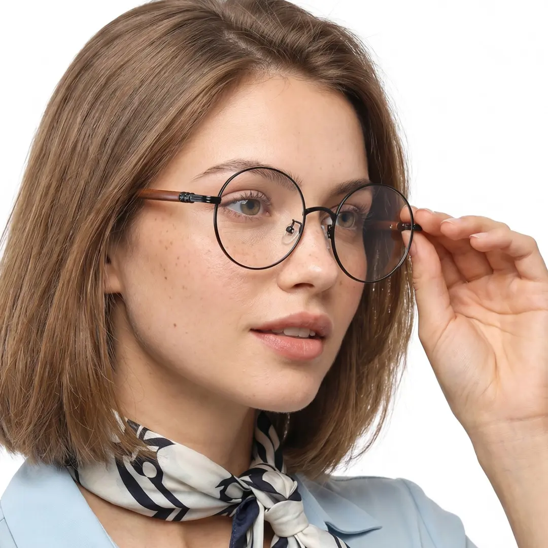 Profile view of female wearing vintage black brown round eyeglasses, touching frame, natural expression, RM0302407