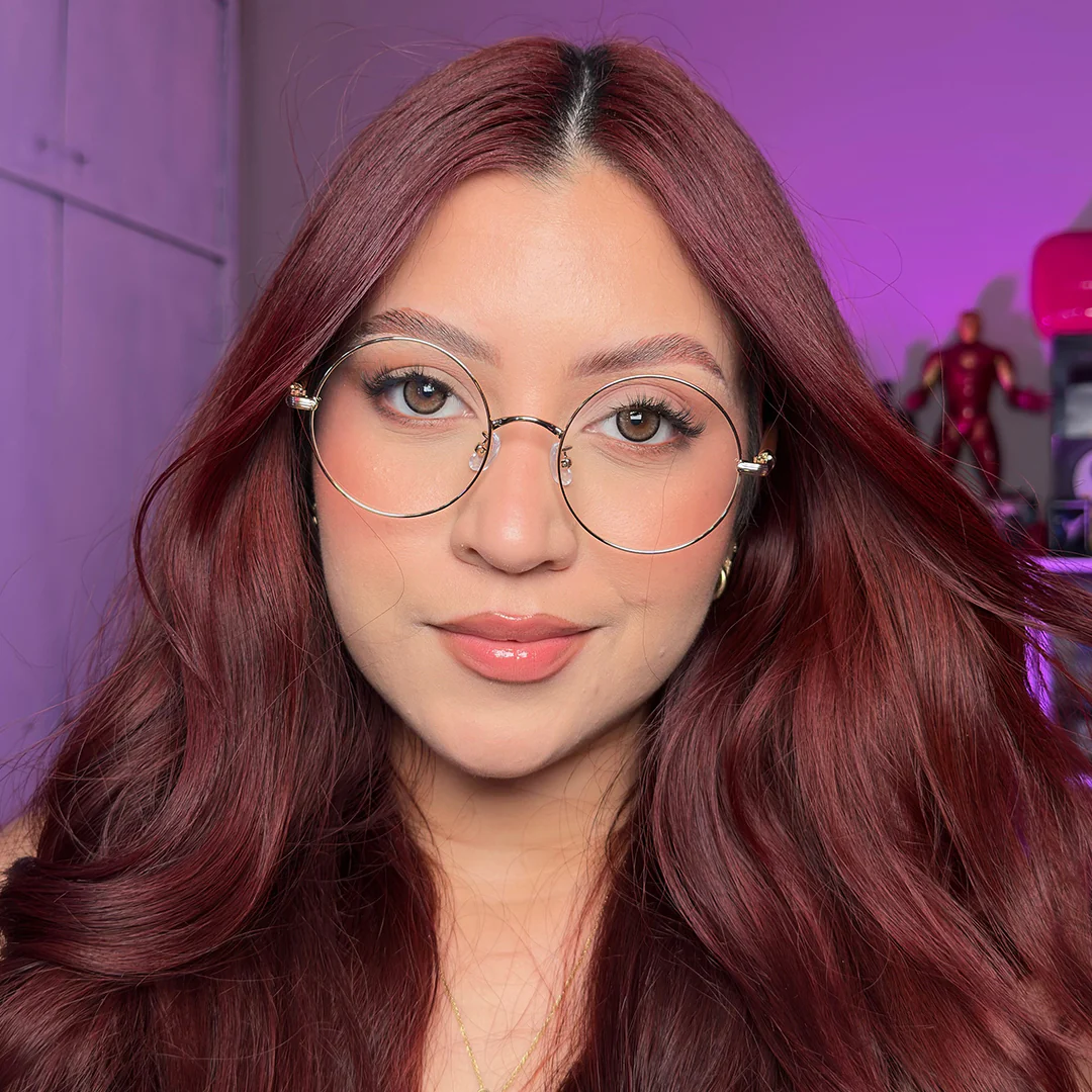 Front view of female wearing vintage gold round eyeglasses, taking a selfie, natural smile, RM0302407