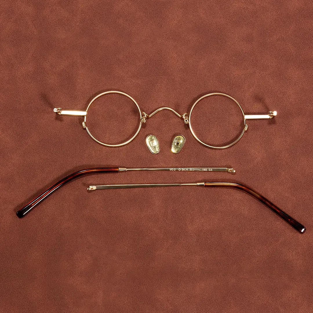 Exploded-view of Eddie round metal eyeglasses RM0352505 in gold
