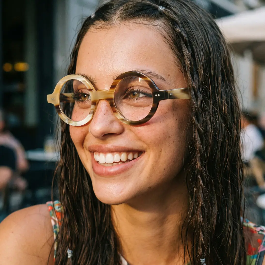 Looking away view of female wearing yellow round eyeglasses, smiling, RO0262511