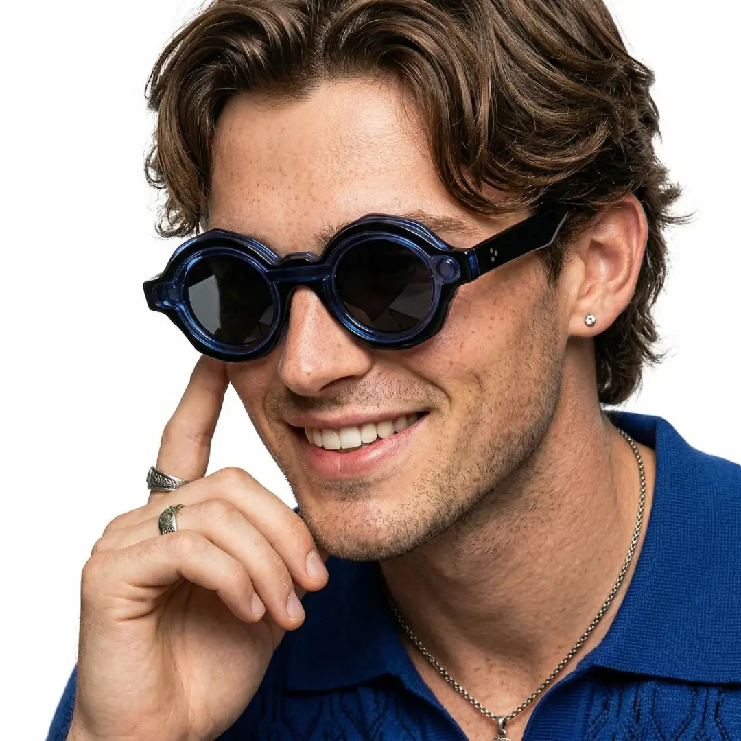 Three-quarter view of male wearing fashion blue round magnetic clip-on eyeglasses set with interchangeable clip-on lenses, adjusting glasses, smiling, RP0012604