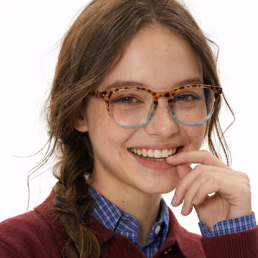 Female wearing two-tone round pc eyeglasses, smiling while looking at camera. SPU: RP0052502