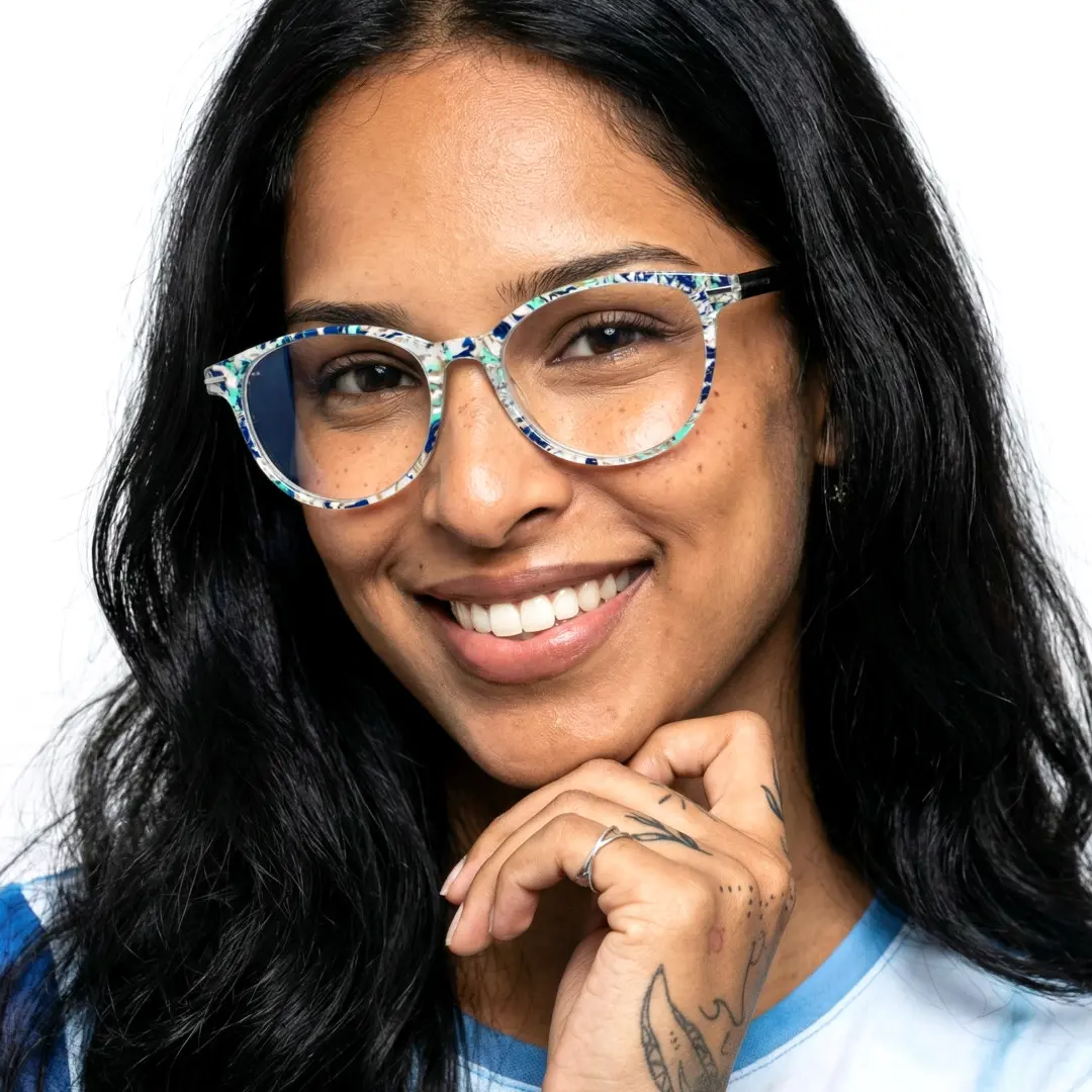 Three-quarter view of female wearing light blue round eyeglasses, natural smile, RP0212409