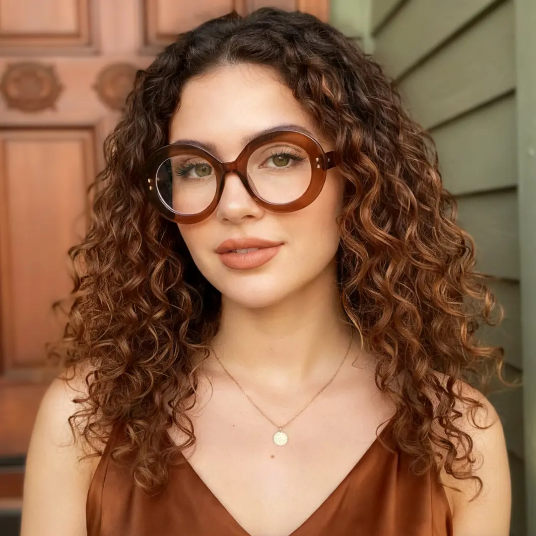 Front view of female wearing brown round eyeglasses, confident expression, RP0322406