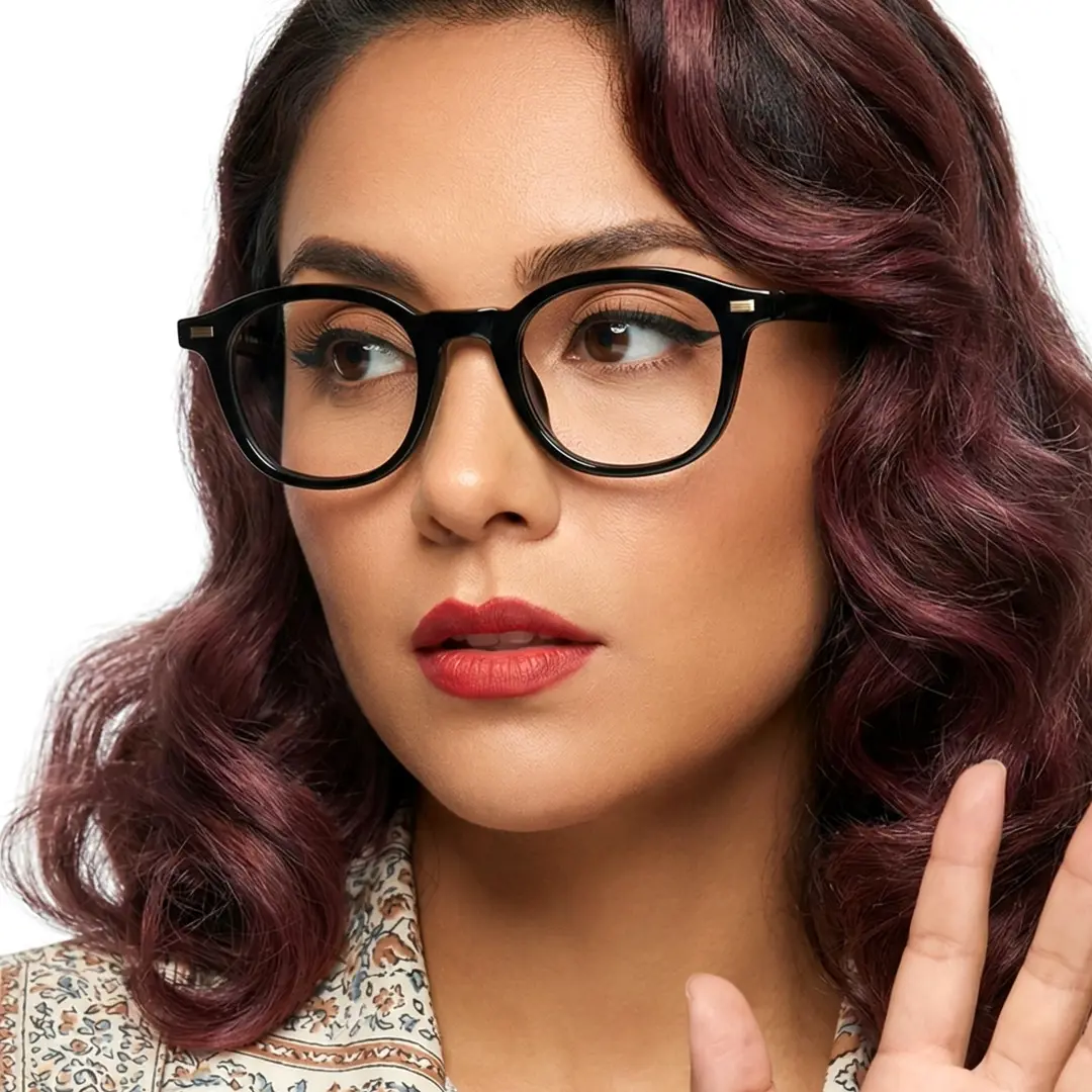 Front view of female wearing black round eyeglasses, soft smile, RR0082412