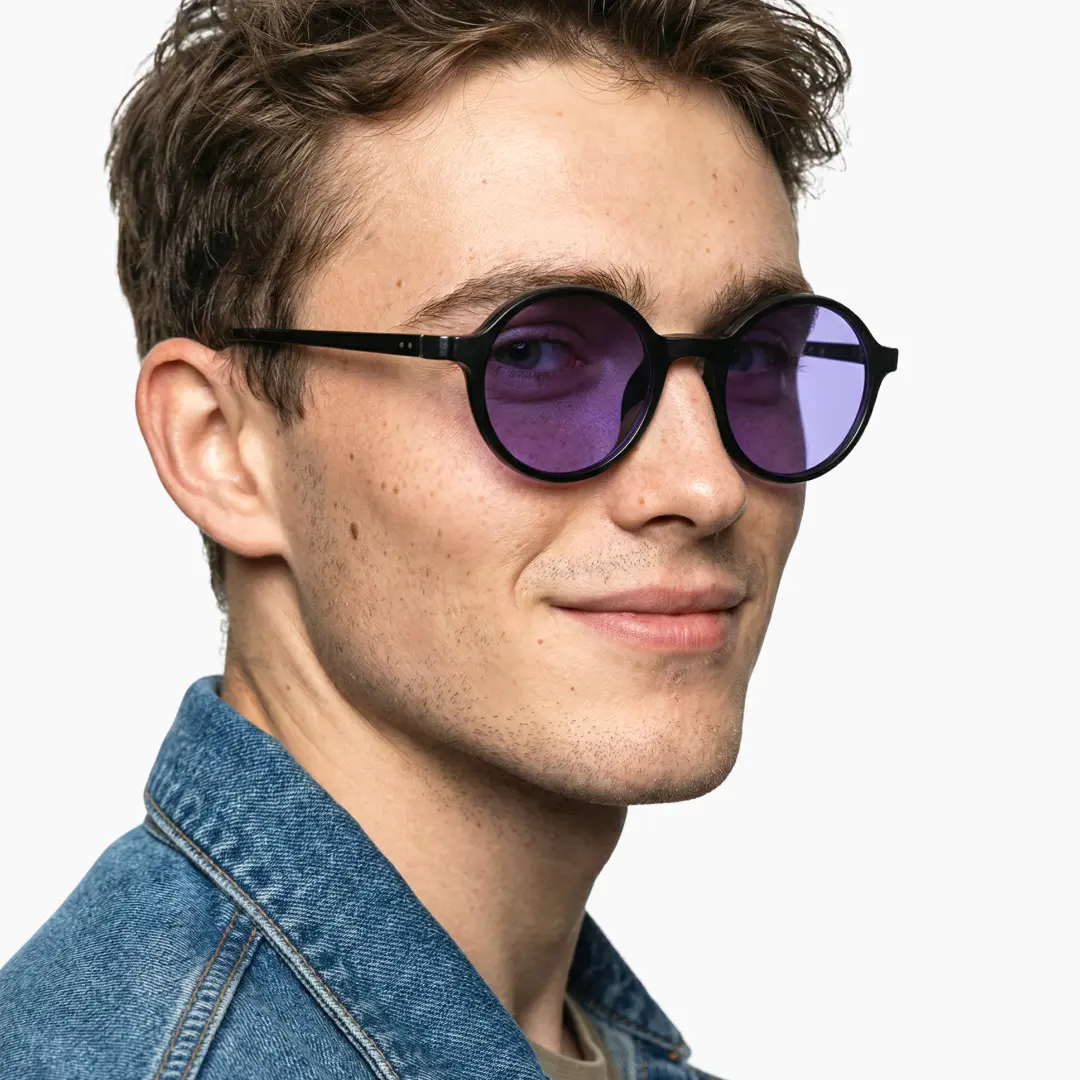 Profile view of male wearing black round magnetic clip-on eyeglasses set with interchangeable clip-on lenses, soft smile, RR0112601