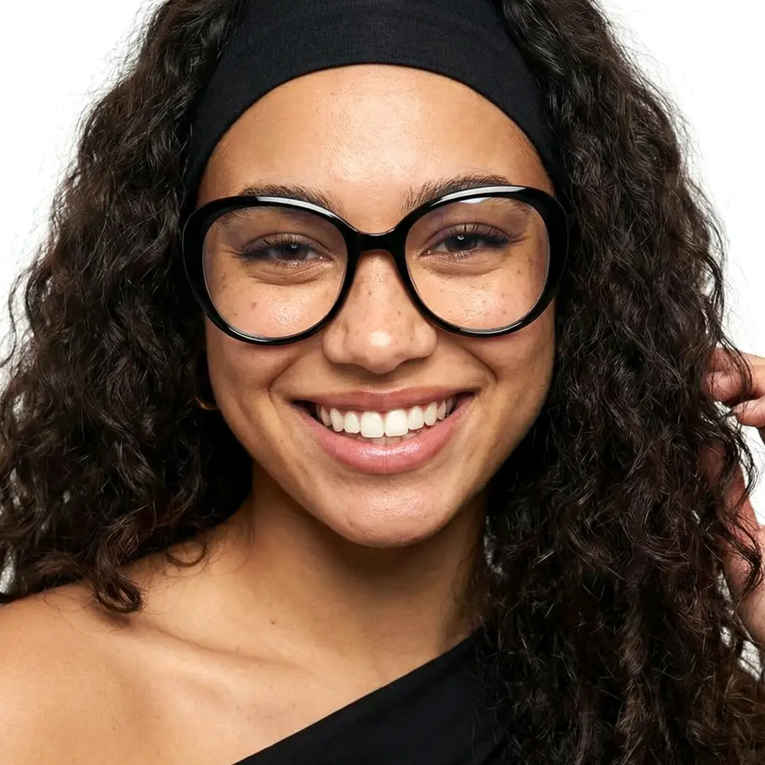 Front view of female wearing black round eyeglasses, smiling, RR0122502
