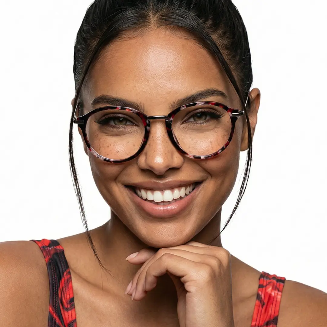 Front view of female wearing red tortoise round eyeglasses, hand touching chin, smiling, RR0202306