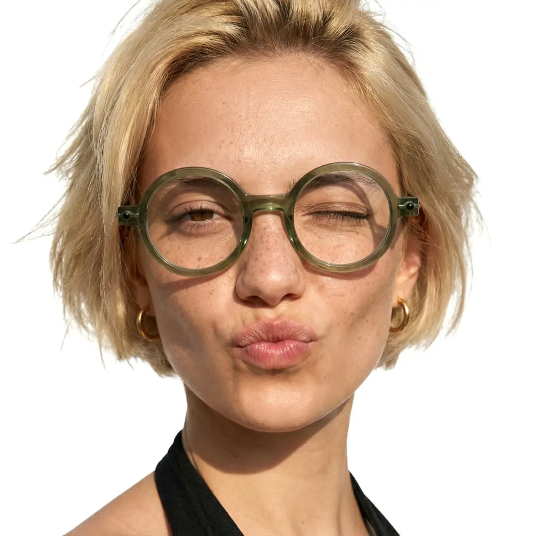 Close-up view of female wearing army green round eyeglasses, pouting, neutral expression, RR0212302