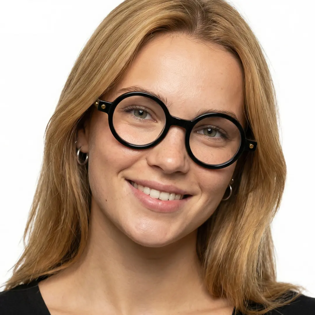 Tilted head view of female wearing black round eyeglasses, smiling, RR0212302