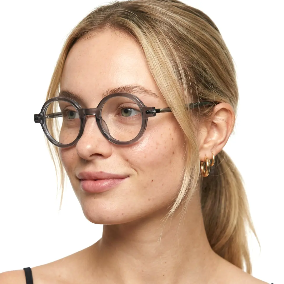 Profile view of female wearing grey round eyeglasses, neutral expression, RR0212302