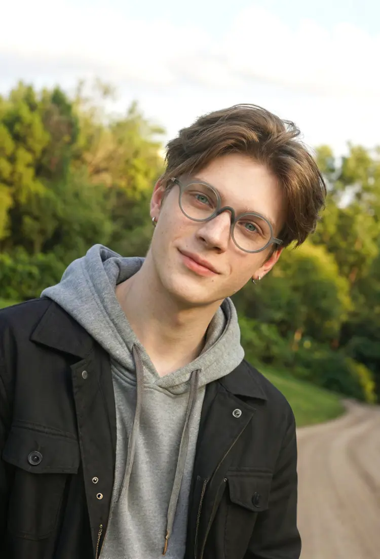 Male model wearing vintage grey round tr90 eyeglasses in a peaceful green park. SPU: RR0282410