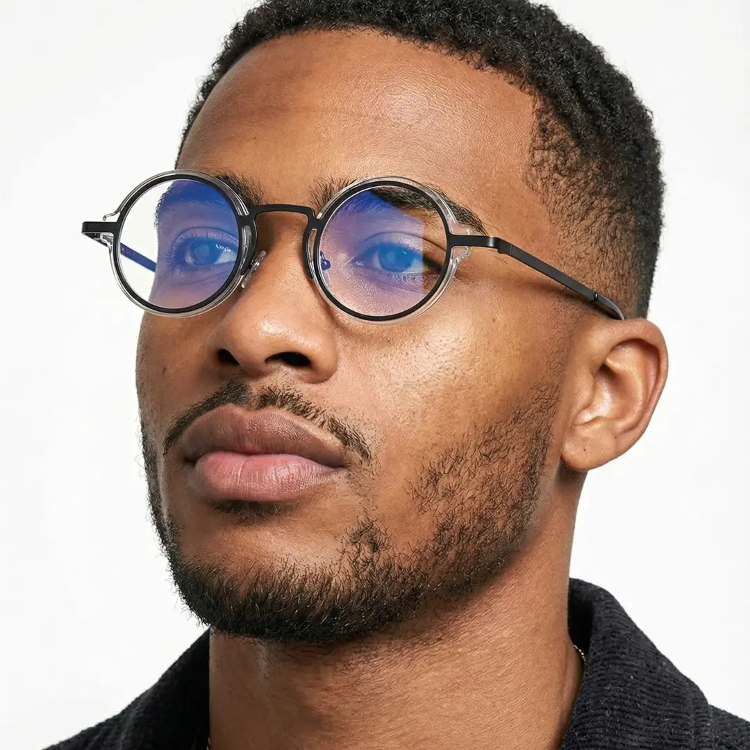 Three-quarter view of male wearing blackclear round eyeglasses, natural expression, RR0312406