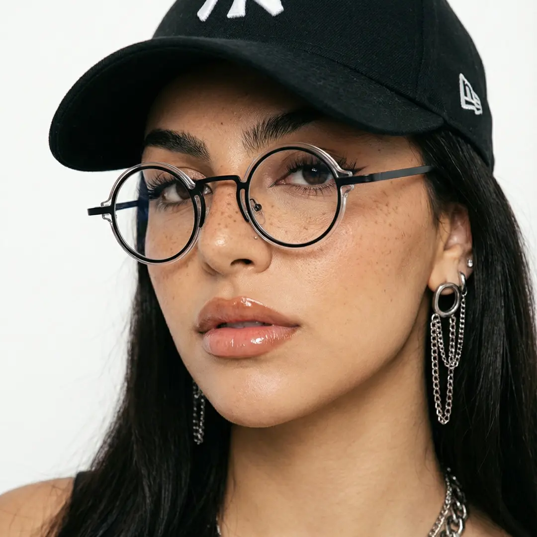 Three-quarter view of female wearing vintage blackclear round eyeglasses, calm expression, RR0312406