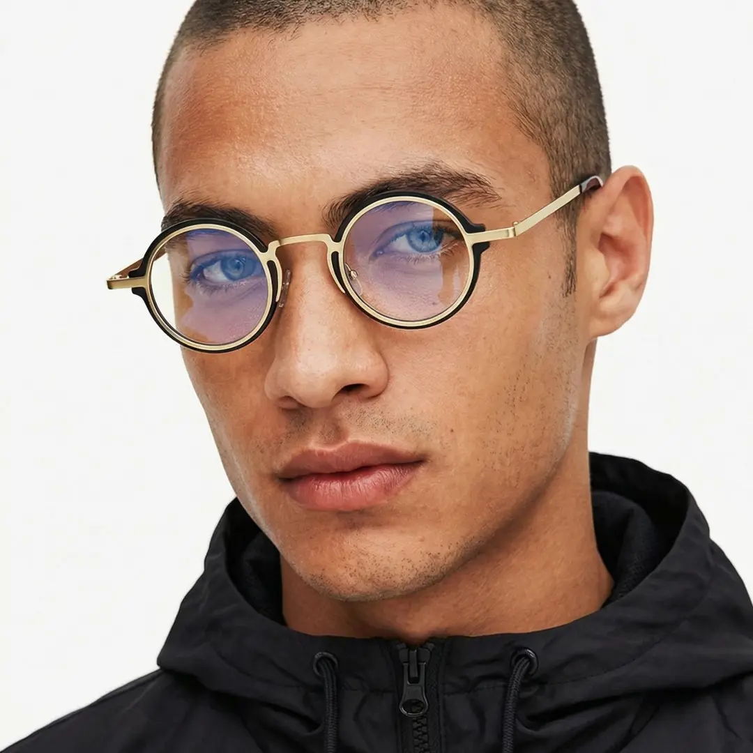 Three-quarter view of male wearing black round eyeglasses, natural expression, RR0312406