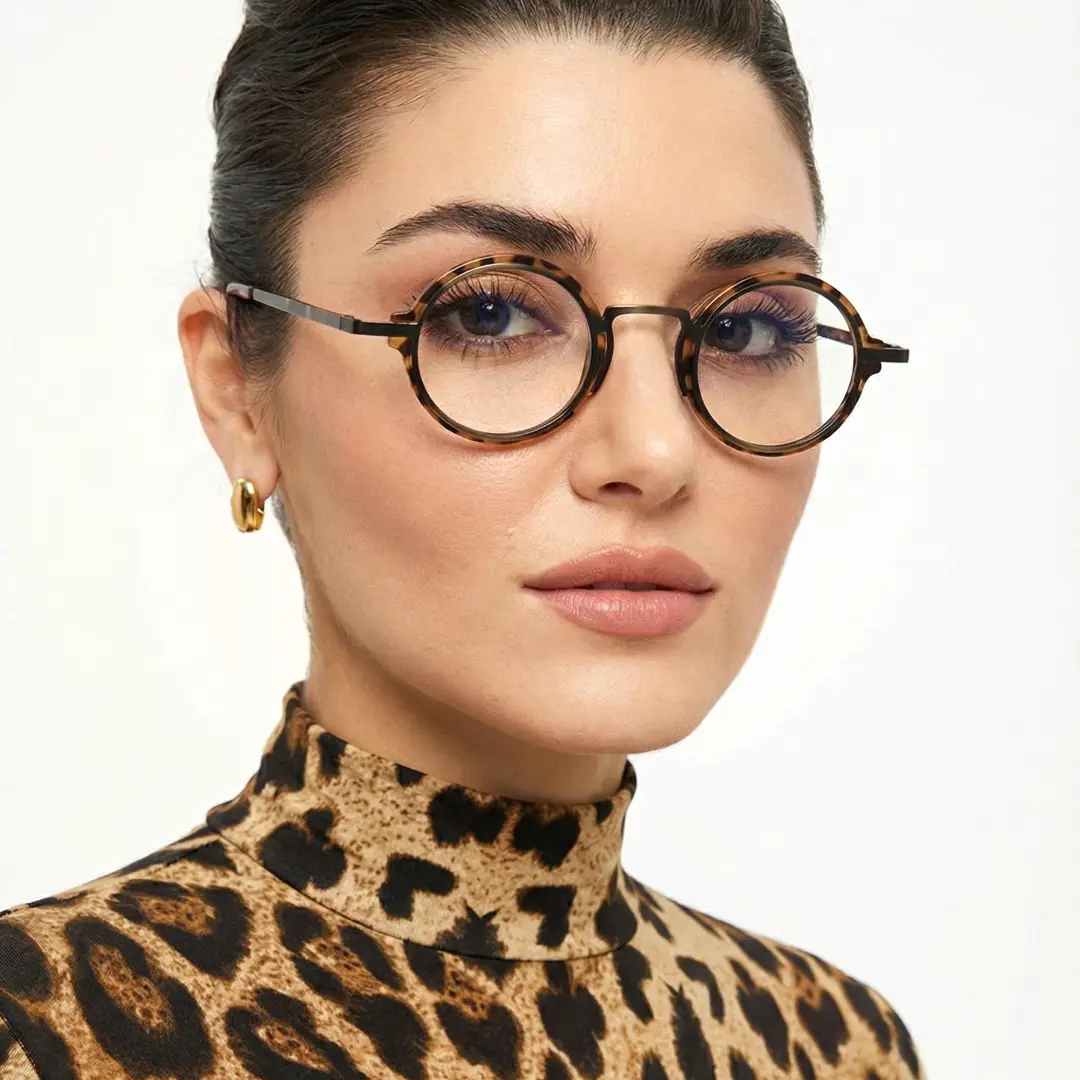 Three-quarter view of female wearing brown tortoise round eyeglasses, neutral expression, RR0312406