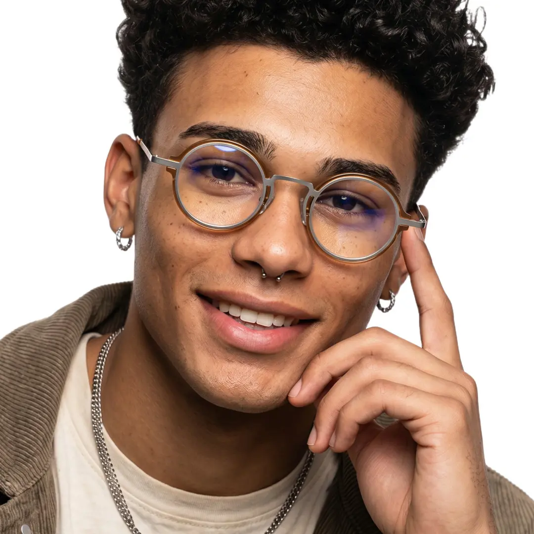 Front view of male wearing vintage gold round eyeglasses, hand near face, smiling, RR0312406