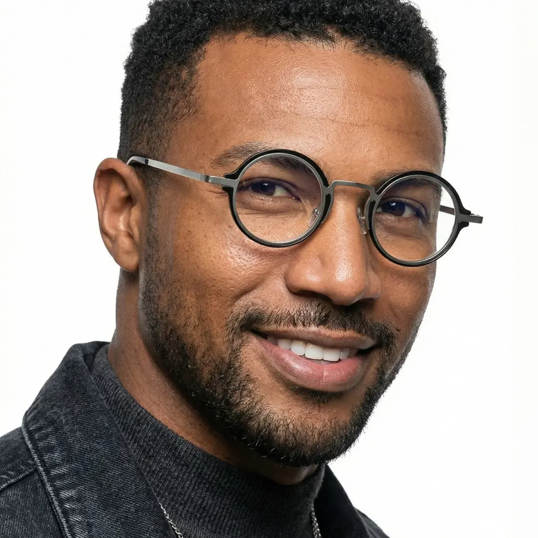 Three-quarter view of male wearing vintage silver round eyeglasses, smiling, RR0312406